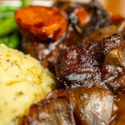 A plate with stout-braised pot roast, close up.