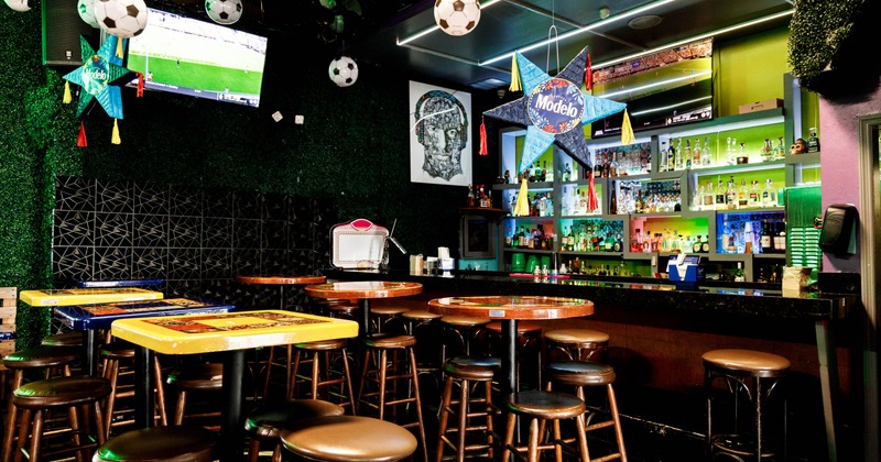Interior, bar area with tall tables and bar stools