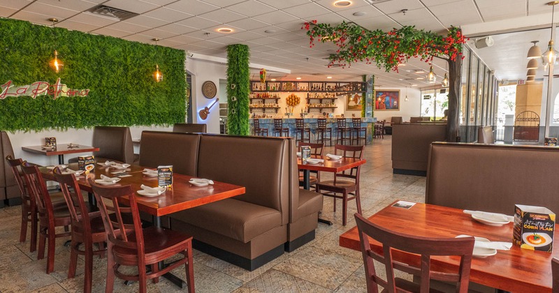 Interior, seating area, banquette benches with tables and chairs, ready for guests