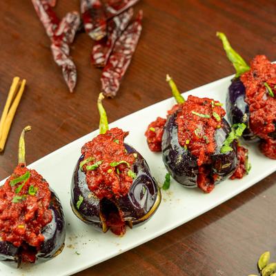 Baby eggplants topped with tawa sauce.