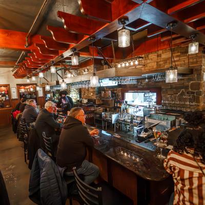 People seated at a long bar counter.