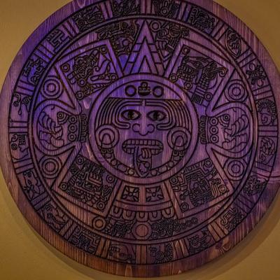 Wooden Mayan calendar on a wall.