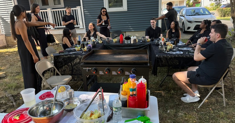 People at a backyard gathering with food and drinks