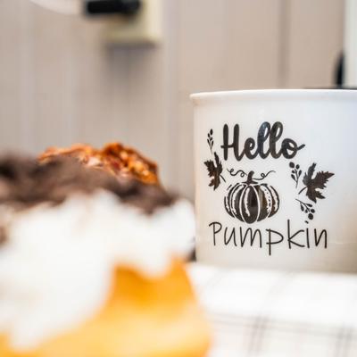 Cup of coffee served alongside couple of donuts.