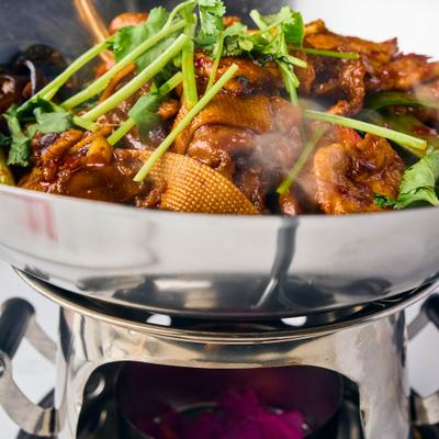Szechuan Chicken Beef Calamari in a wok.