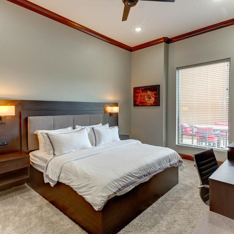 A large bed, bedside tables with lamps.