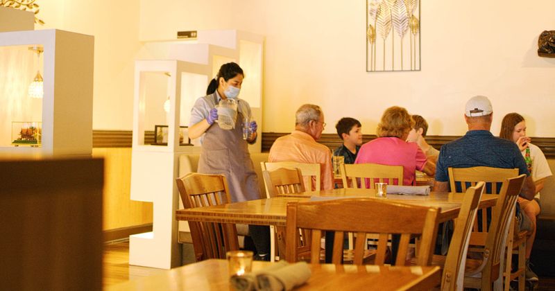 waitress serving a full table