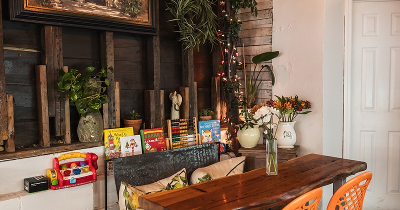 Interior, cozy seating area, wooden table in the corner