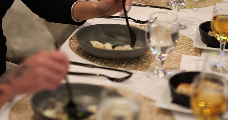 Guests enjoying dinner, focus on the plate