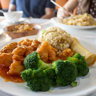 Sesame chicken, served with rice and broccoli.