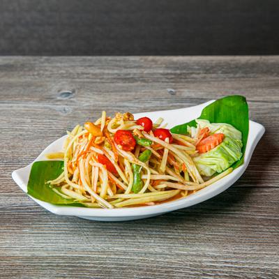 Green papaya salad with chili lime sauce, green bean, tomato, and peanuts.