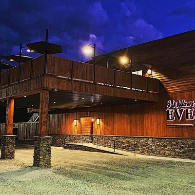 The event center entrance illuminated at night.
