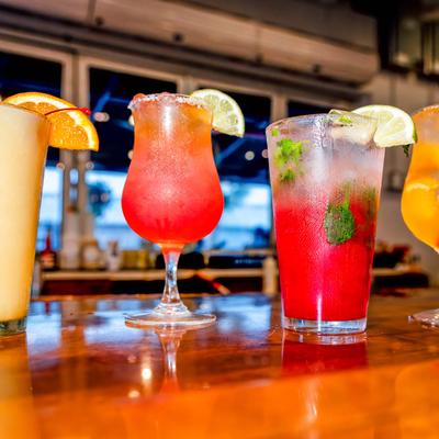 Various cocktails lined up, front view.