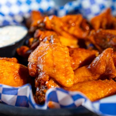 Bone-In Chicken Wings in our Original Hot Sauce served with a side of ranch dressing.