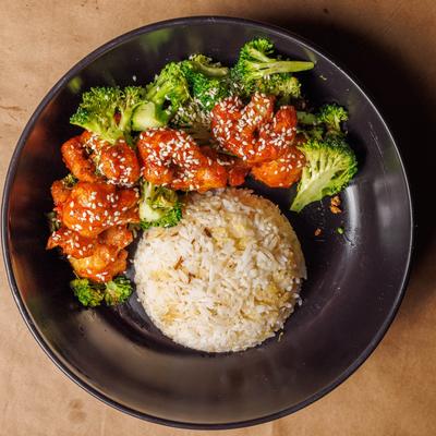 Sweet chili cauliflower florets with sesame seeds, served with rice and broccoli.