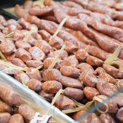 A selection of fresh Italian sausages in a market setting.