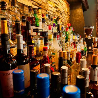 Assorted liquor bottles on a bar shelf.