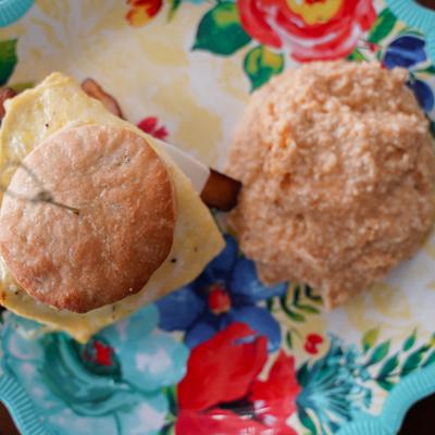 Bacon, Egg, &and Cheese Biscuit sandwich, served with cheesy grits.