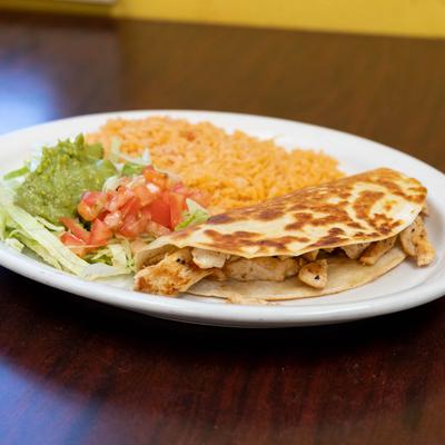 Chicken Quesadilla, with lettuce, tomato, rice, and guacamole.