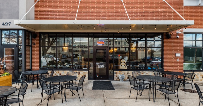 Exterior, seating area with tables and chairs in front of the entrance