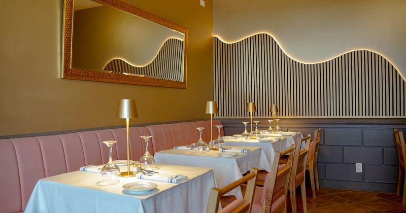 Interior, booths near the wall with tables and chairs