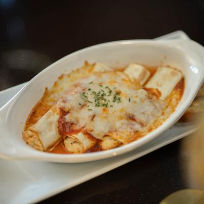Manicotti covered in melted cheese.