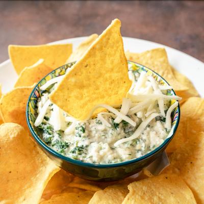 Spinach artichoke dip served with tortilla chips.