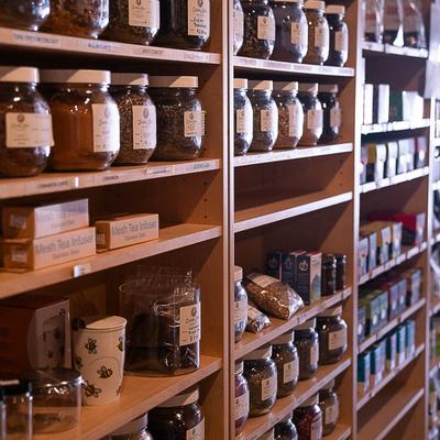 Herb shop shelves with product jars.