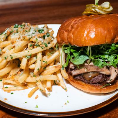 Mushroom cheeseburger, with arugula, served with fries.