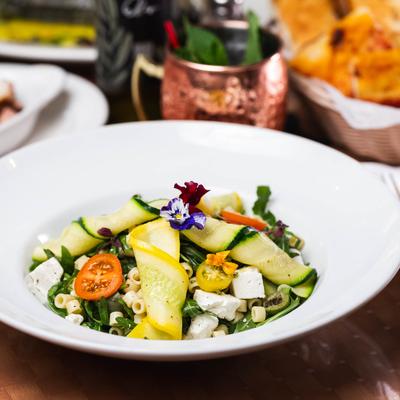 Pasta salad, with cucumber, arugula, tomatoes, olives, arugula, and feta.