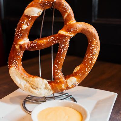 A large Bavarian soft pretzel served with warm beer cheese