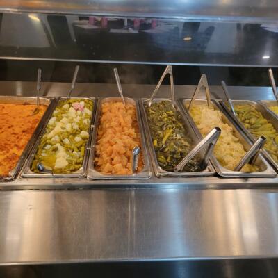 Buffet bar with assorted vegetable side dishes.