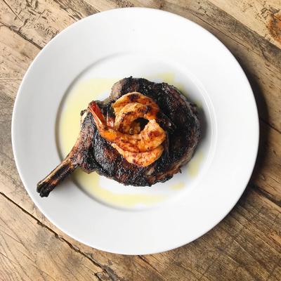 Ribeye steak topped with shrimp.