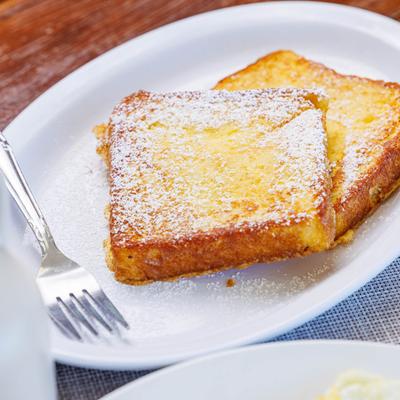 Thick-cut French toast with powdered sugar.