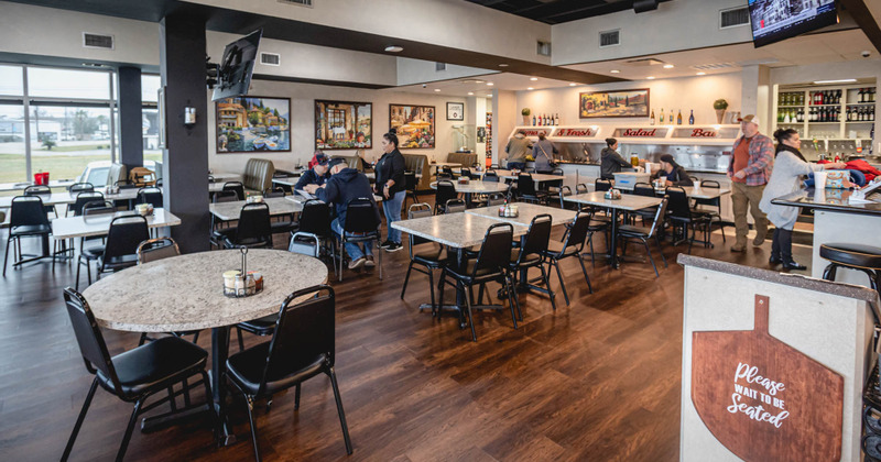 Interior, dining tables with guests sitting