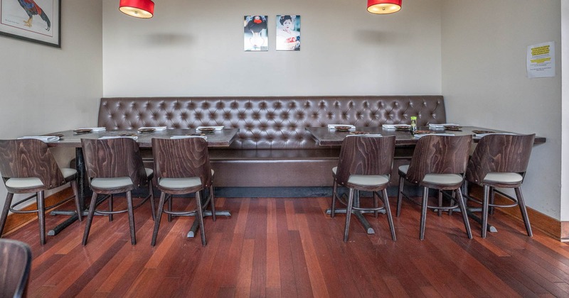 Interior, a table with tableware, leather bench seating, chairs