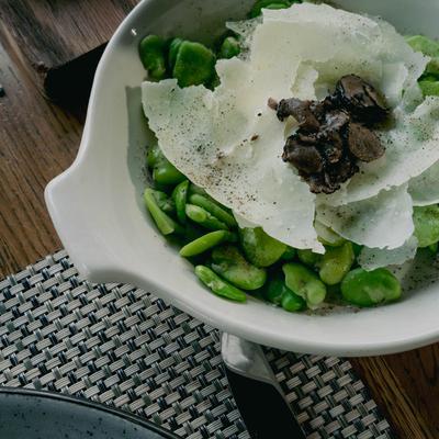 Dish of Warm Fava Beans, Pecorino cheese, and  Black Truffle Carpaccio.