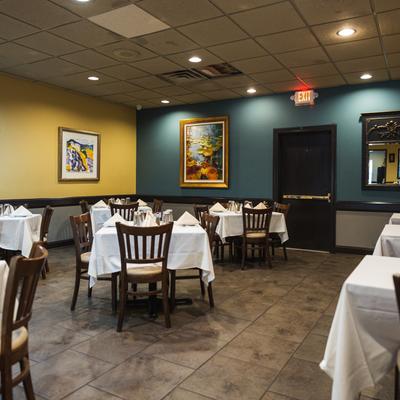 Interior, set tables, chairs, paintings, lighting