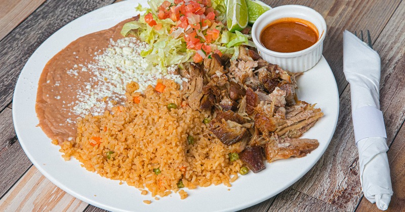 Pork chunks, with rice, beans, pico de gallo, and lettuce