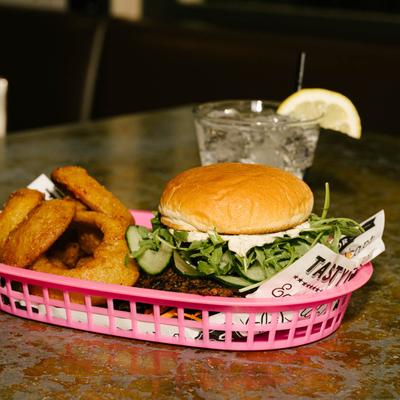 Beet box sandwich with onion rings, served in a basket.