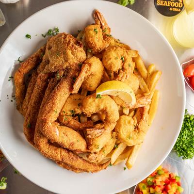 Fried crab legs, shrimp, and fries.
