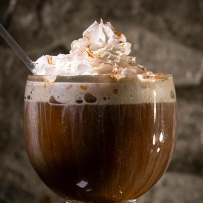 Coffee drink topped with whipped cream.