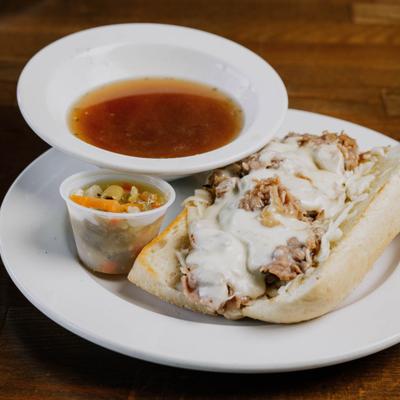 Italian beef sandwich served with au jus and pickled veggies.