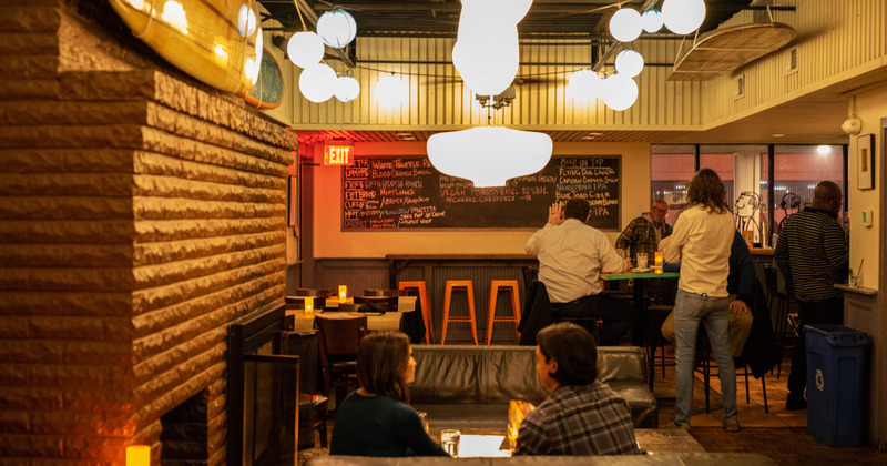 Interior, guests sitting at tables and in a booth