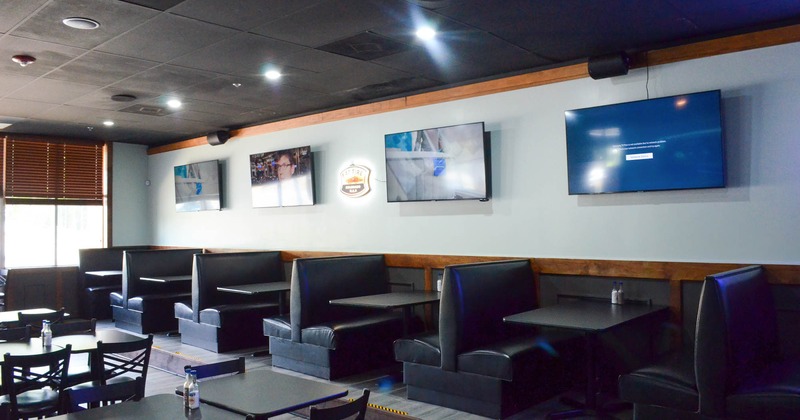 Interior, dining booths, TVs on the wall