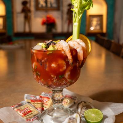 Shrimp cocktail served with fresh oysters, crackers and a lime wedge.