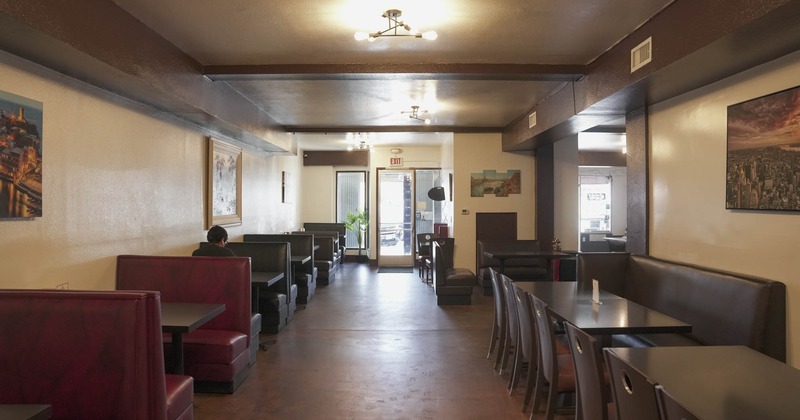 Interior, seating booths on the left, banquette bench with table and chairs on the right