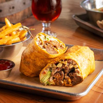 Shiitake mushroom wrap with fries, ketchup, and a beer.
