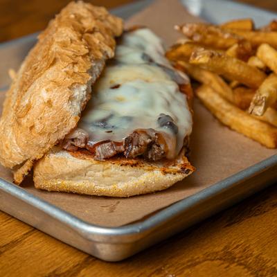 Smoked Brisket on french roll with a side of fries.