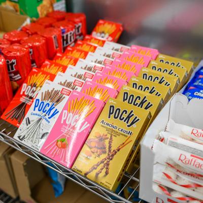 Various chocolate-covered biscuit sticks displayed on a shelf.